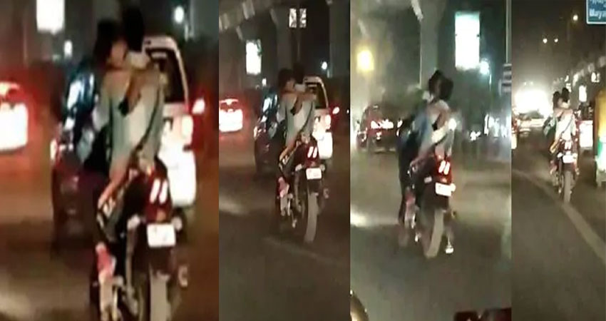चलती बाइक के फ्यूल टैंक पर बैठकर फिल्मी अंदाज में किस करता नजर आया ये कपल, Video वायरल चलती बाइक के फ्यूल टैंक पर बैठकर फिल्मी अंदाज में किस करता नजर आया ये कपल, Video वायरल